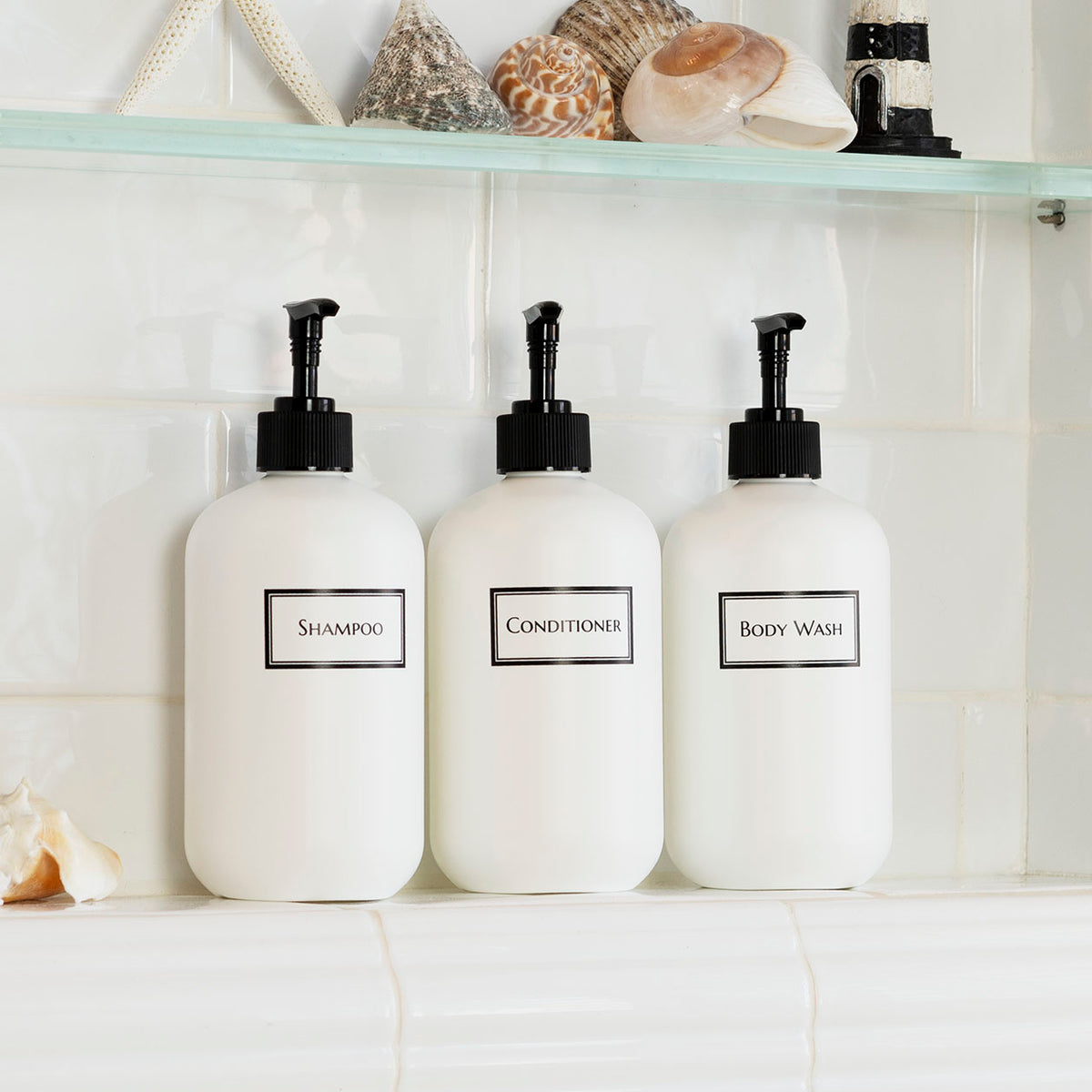 white refillable plastic shampoo bottle set with minimalist labels for bathroom renovation.