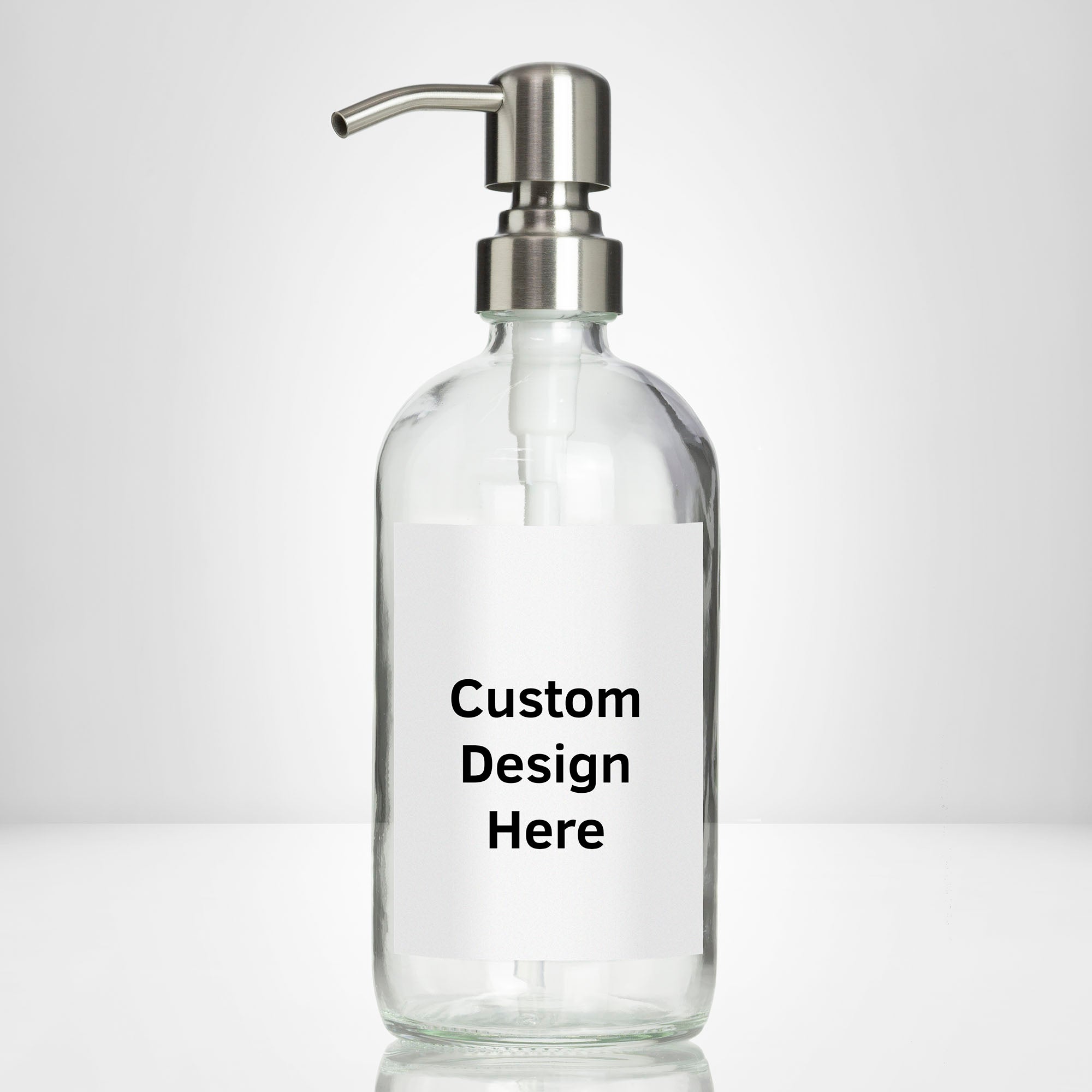Elegant clear glass 16 oz boston round bottle personalized customized with waterproof label, printed on demand with choice of pumps including stainless steel for kitchen, amenities, hospitality, businesses, bathrooms.