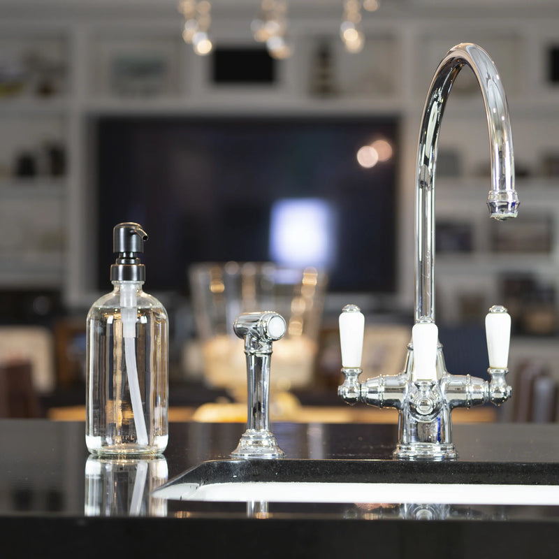 A sleek kitchen sink featuring a modern faucet and soap dispenser, perfect for stylish and functional home decor.