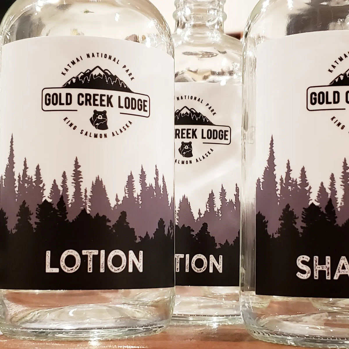 Glass bottles and label. Label reads: Gold Creek Lodge, Lotion