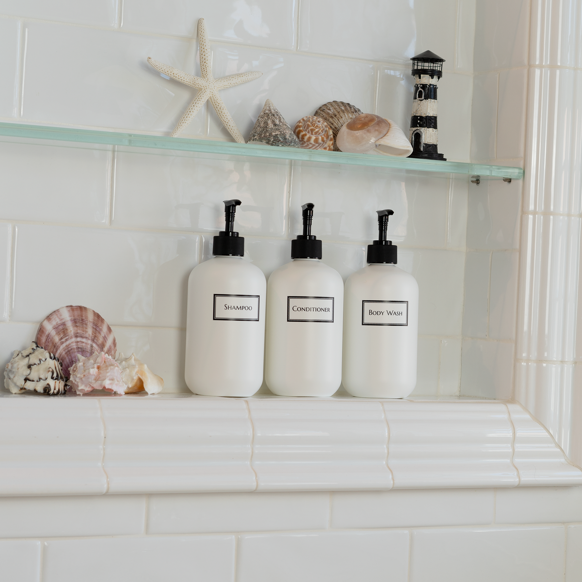 Decorative trio of white plastic bottles with minimalist design,  squat shape to fit shower niche
