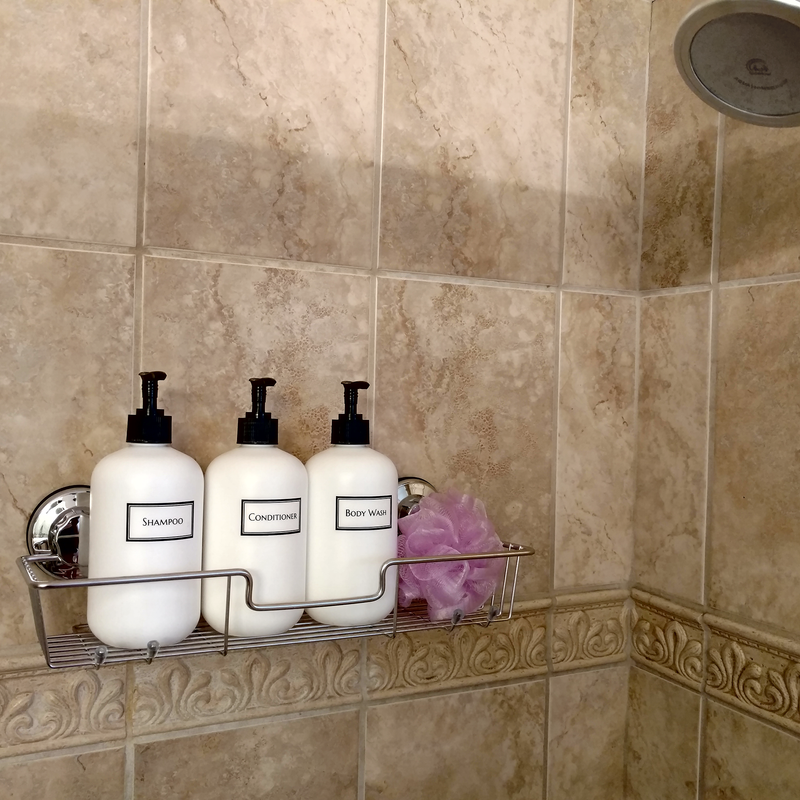 Artanis Home trio of white pump bottles printed with "Shampoo", "Conditioner", and "Body Wash" to declutter and organize the shower