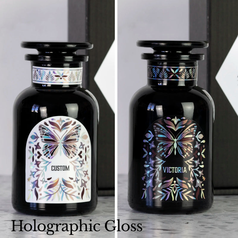 Two Miron apothecary jars with custom black and white holographic labels and butterfly design.