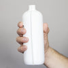 Hand holding the 19 oz bottle for a size reference.