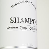Detailed closeup of the shampoo bottle label with detailed chrome accents in lines and lettering.
